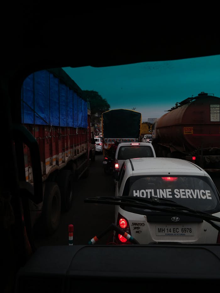 Captured at Chakan, this image depicts a busy road with several vehicles, including trucks and cars, amidst heavy traffic.